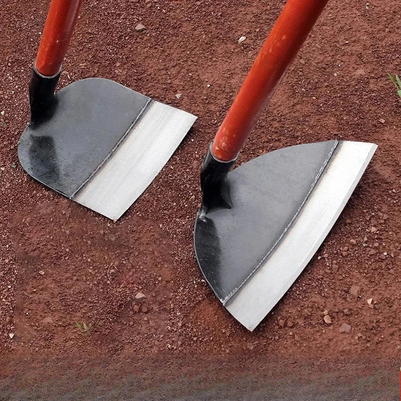 A pair of red-handled manganese steel garden hoes resting on brown soil.