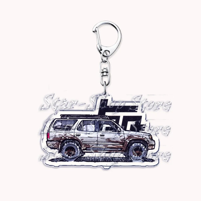 A silver metal key ring attached to a durable keychain featuring an off-road truck design.