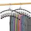Stainless steel space-saving hanger with ten clips displaying various colored shirts.