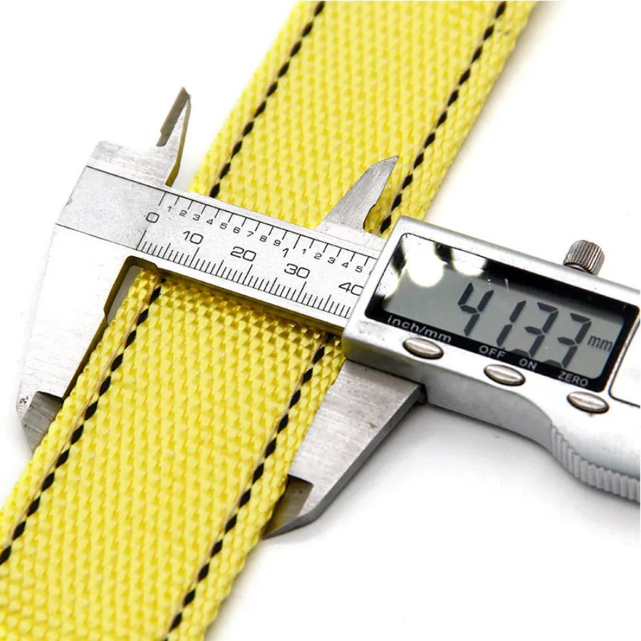 A yellow heavy-duty car tow strap is shown next to a digital caliper measuring its dimensions.