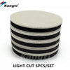 A set of five black and white light cut polishing wool pads for car scratch removal