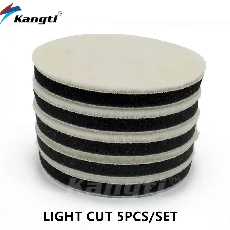 A set of five black and white light cut polishing wool pads for car scratch removal