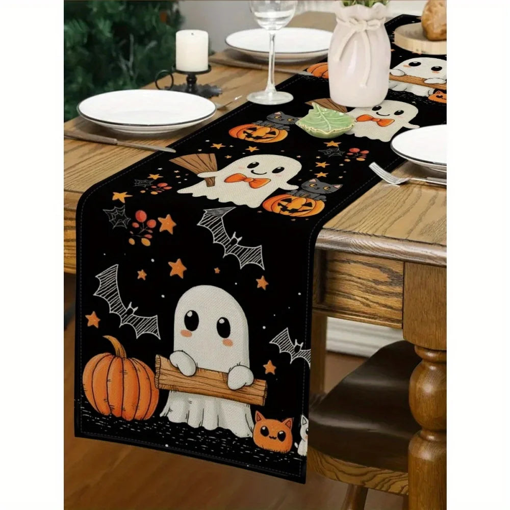 Black Halloween table runner featuring orange pumpkins, bats, and jack-o'-lanterns