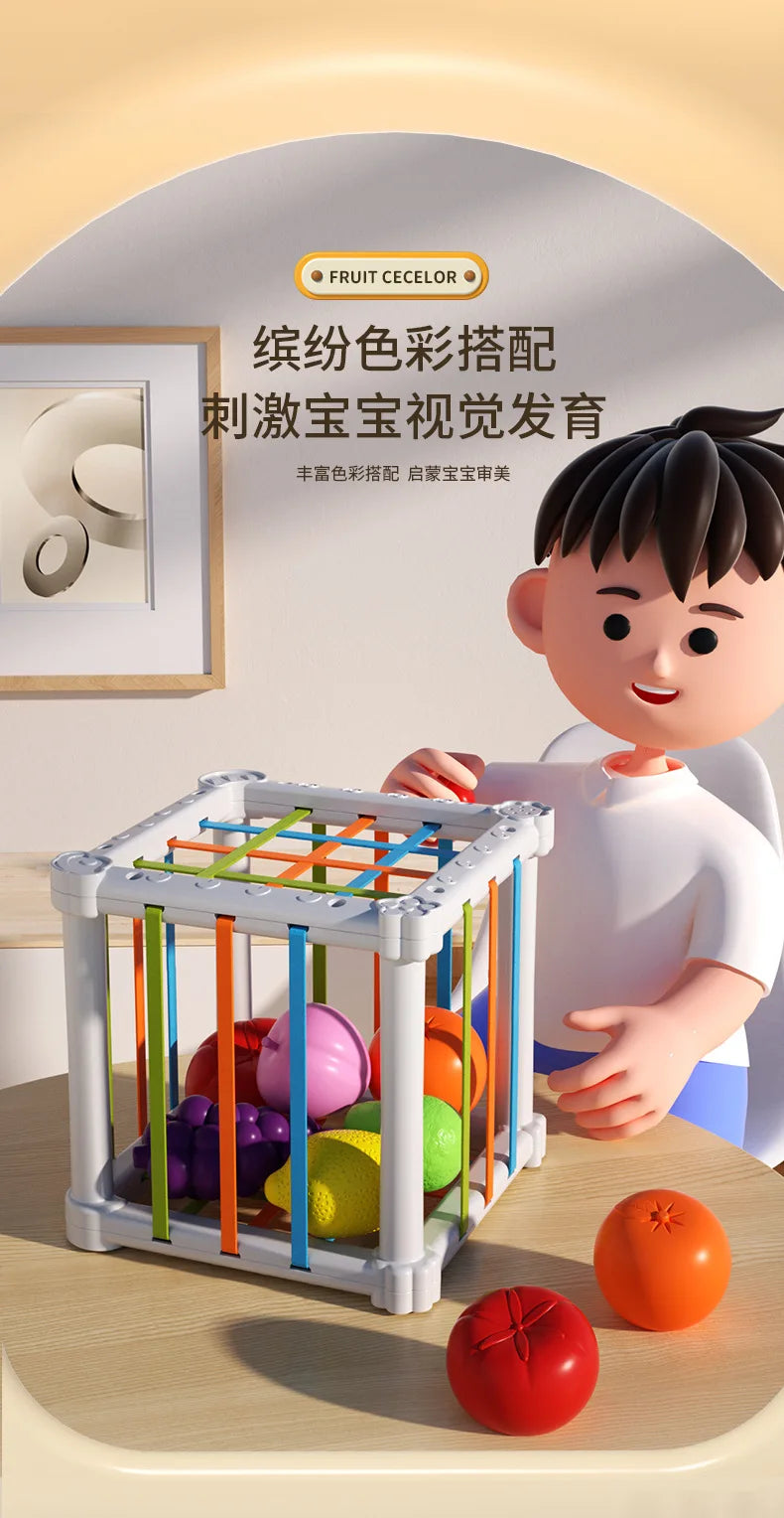 A white cube sorter filled with colorful fruit shapes secured by soft elastic bands, shown next to a child.