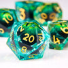 A close-up of a translucent teal resin die with a dragon eye design, surrounded by other green dice.
