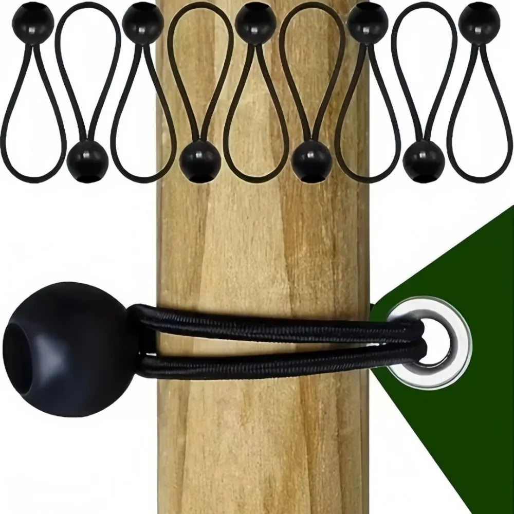 Black elastic tent tie-down ropes with plastic buckles hanging on a wooden pole.