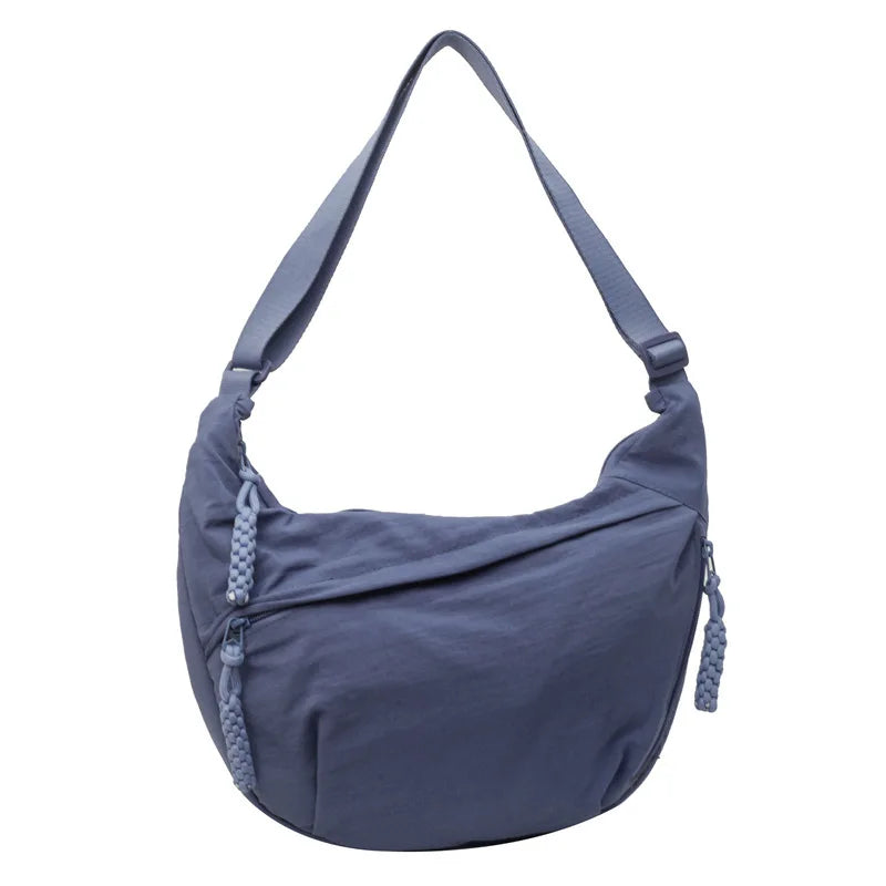 A navy blue lightweight nylon crossbody bag with adjustable straps.
