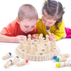 Two children are playing with a wooden memory chess game featuring colored pieces.