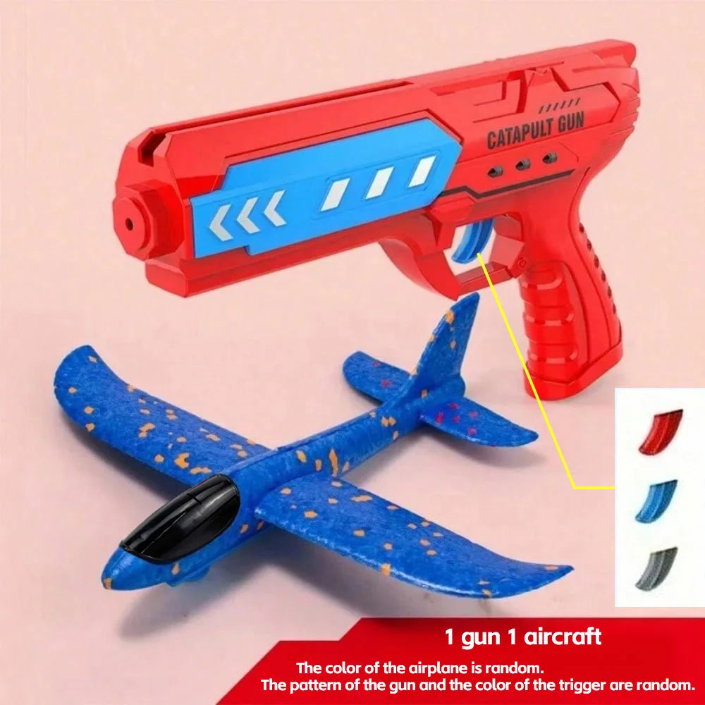 A red catapult gun and a blue patterned airplane are shown together as an outdoor flying toy set.