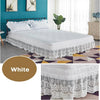 White ruffled lace bed skirt with elastic fit displayed on a bed in a modern bedroom.