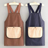 A brown striped waterproof kitchen apron with a removable tan towel hanging on a wooden hanger.