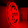 A bright red neon sign shaped like a bottle with a cap, featuring the Nuka Cola logo.