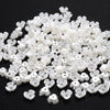 A pile of 100 white acrylic pearl spacer beads for jewelry making