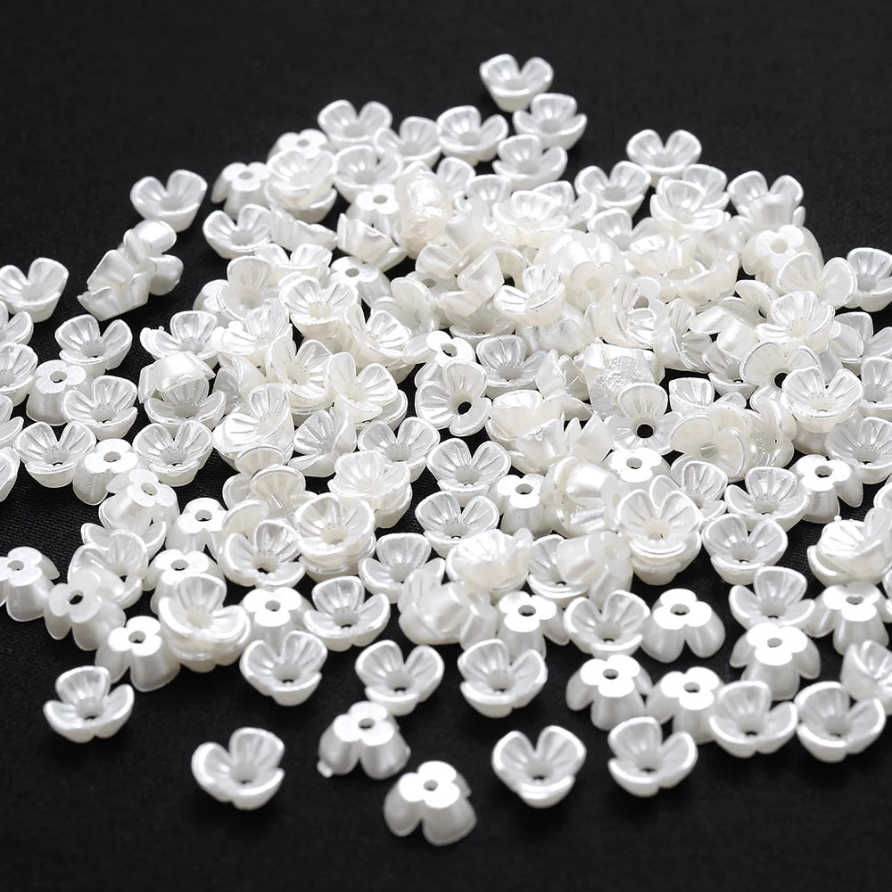 A pile of 100 white acrylic pearl spacer beads for jewelry making