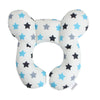 A white baby head and neck support pillow with blue stars and black stars.