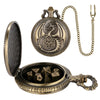 A brass dragon-themed pocket watch dice case with a hinged lid and a chain for carrying the 7 metal polyhedral dice.