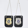 A black police badge role-play accessory with a gold emblem and silver chain hanging from it.