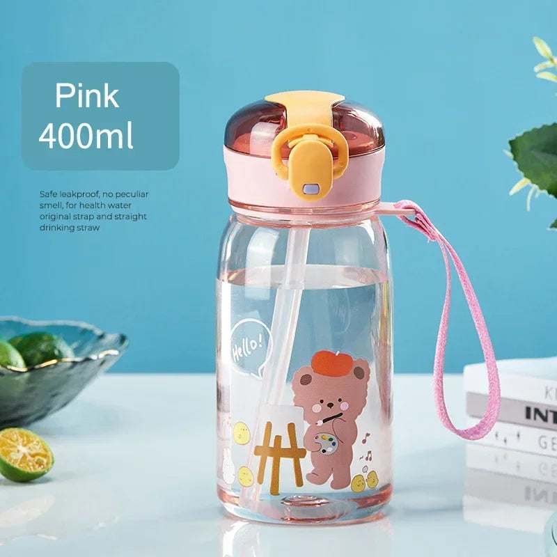 A pink glass water bottle with a yellow lid and a cartoon bear design, featuring a pink strap for carrying.