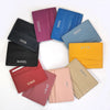 A collection of genuine leather slim card holder wallets in various shades including purple, blue, black, orange, and beige.