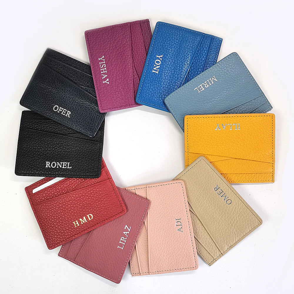 A collection of genuine leather slim card holder wallets in various shades including purple, blue, black, orange, and beige.