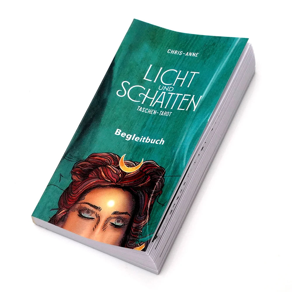 A green deck of Light and Shadow Tarot cards with a guidebook cover featuring a woman's face.