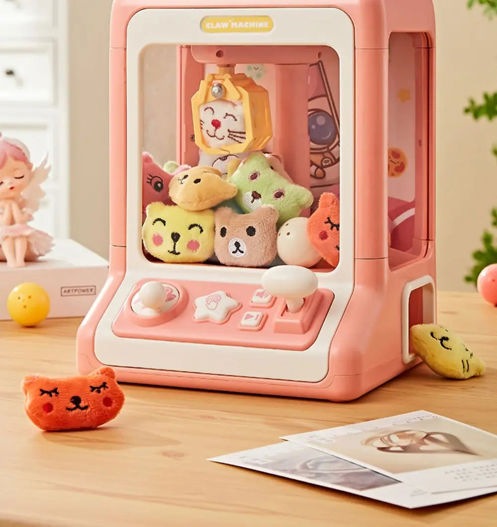 A pink mini claw machine toy featuring various animal figures with lights and music.