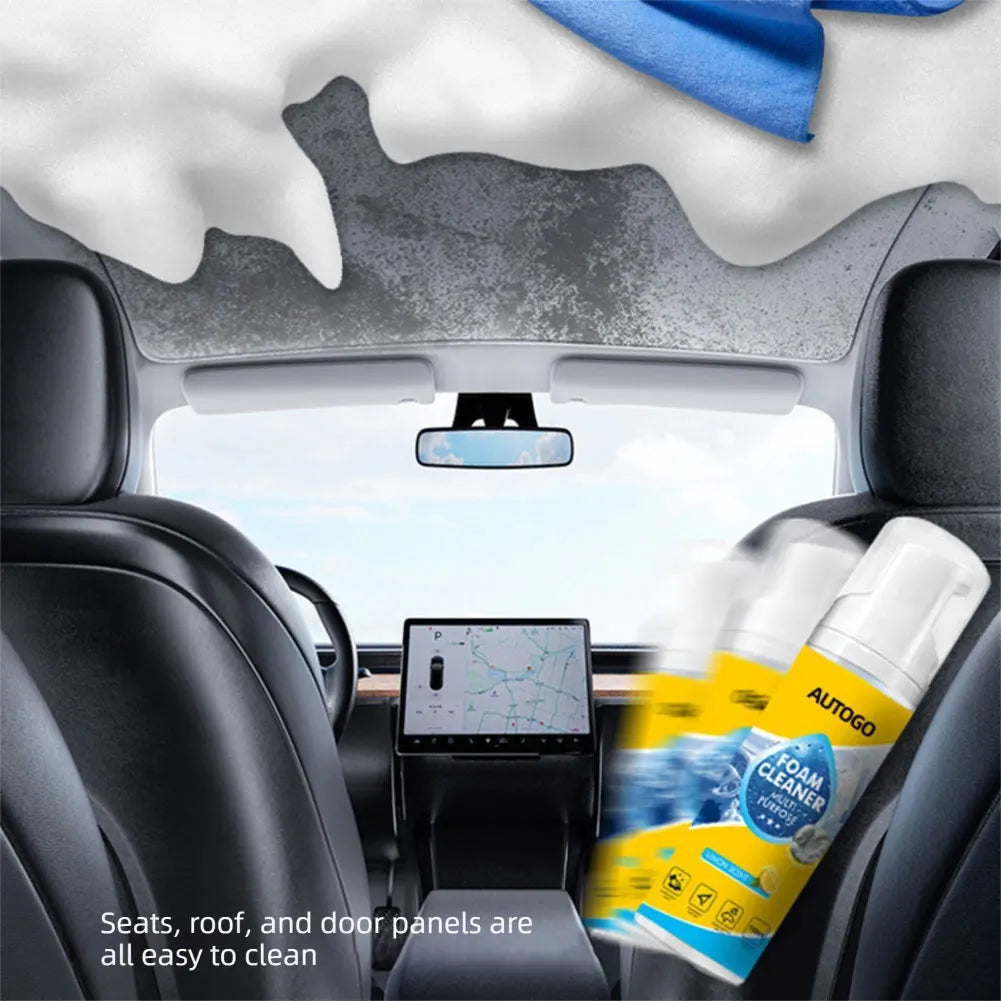 A car interior showing seats, roof, and door panels being cleaned with a foam cleaner.