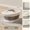 A white foldable foot bath tub with a lid and a gray base is shown on a wooden floor.