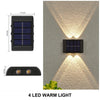 A solar powered wall light featuring four LED warm lights providing upward and downward illumination on a textured wall.