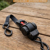 Black auto retractable tie-down straps with a ratchet mechanism resting on a wooden surface.