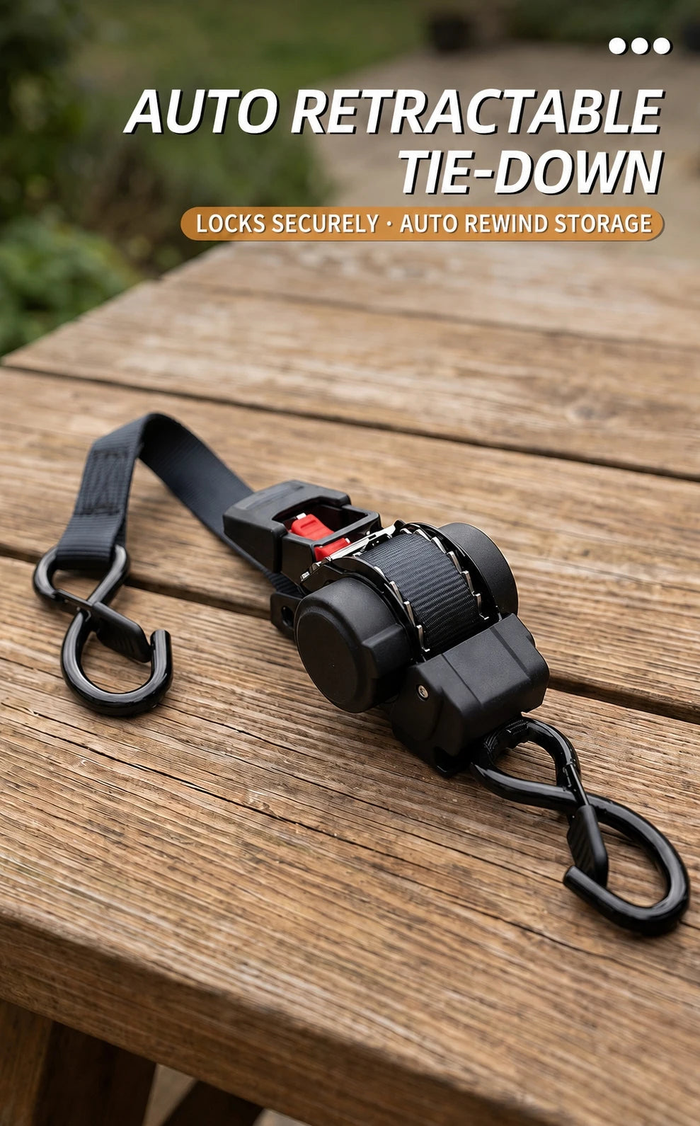 Black auto retractable tie-down straps with a ratchet mechanism resting on a wooden surface.