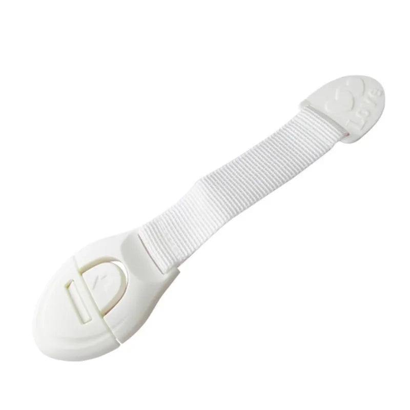 White adhesive baby proofing latch for drawers and cupboards, used as a child safety cabinet lock.