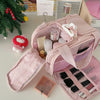 A pink cosmetic travel organizer bag with multiple compartments and a matching pink cosmetic case is shown on a light surface