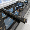 Black marble peel-and-stick film used as a kitchen backsplash, displayed on a countertop.
