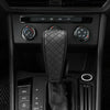 A close-up view of a black PU leather car gear shift cover with a quilted texture, shown in a vehicle interior console.