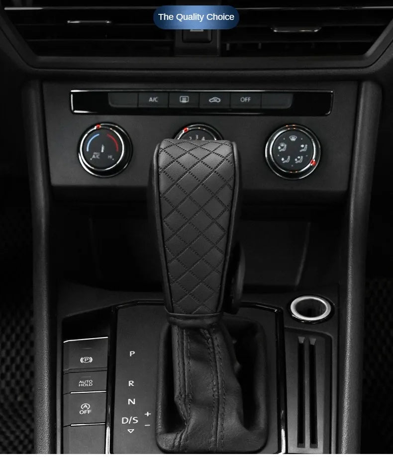 A close-up view of a black PU leather car gear shift cover with a quilted texture, shown in a vehicle interior console.