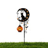 A black cat and pumpkin silhouette on a decorative garden stake light featuring a crescent moon.