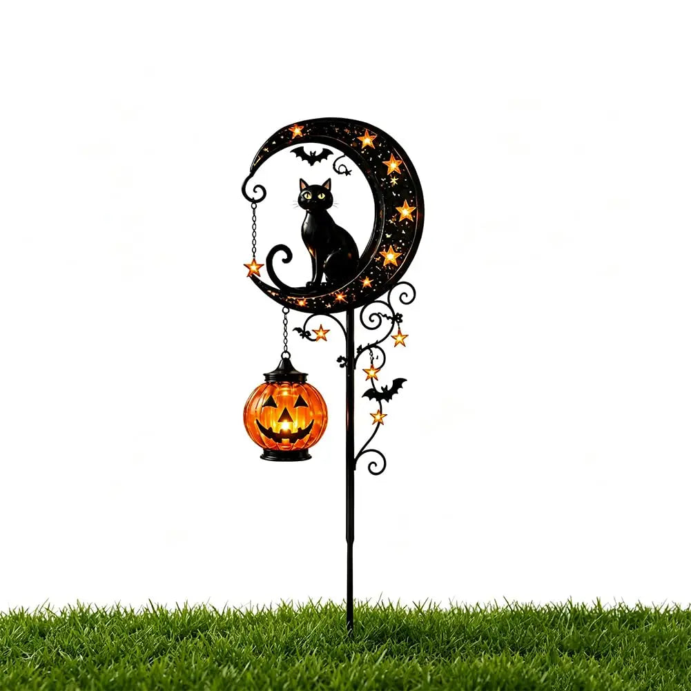 A black cat and pumpkin silhouette on a decorative garden stake light featuring a crescent moon.
