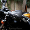 Close-up of black and silver aluminum motorcycle handguards with an Acerbis grip installed on a bike.