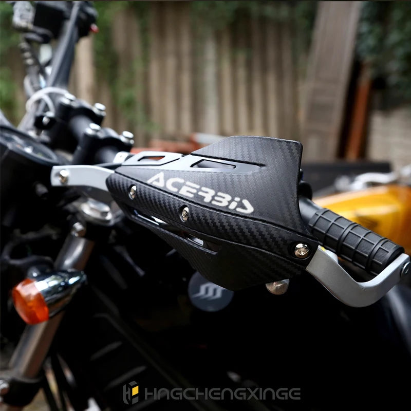 Close-up of black and silver aluminum motorcycle handguards with an Acerbis grip installed on a bike.