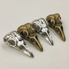 A set of five gothic skull and crow head charms for jewelry making, featuring antique gold and silver finishes.