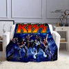 A dark blue flannel throw blanket featuring a graphic print of the Kiss band members.