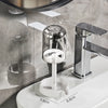 A modern chrome toothbrush holder with a dust cover and drainage mechanism mounted on a white bathroom sink.