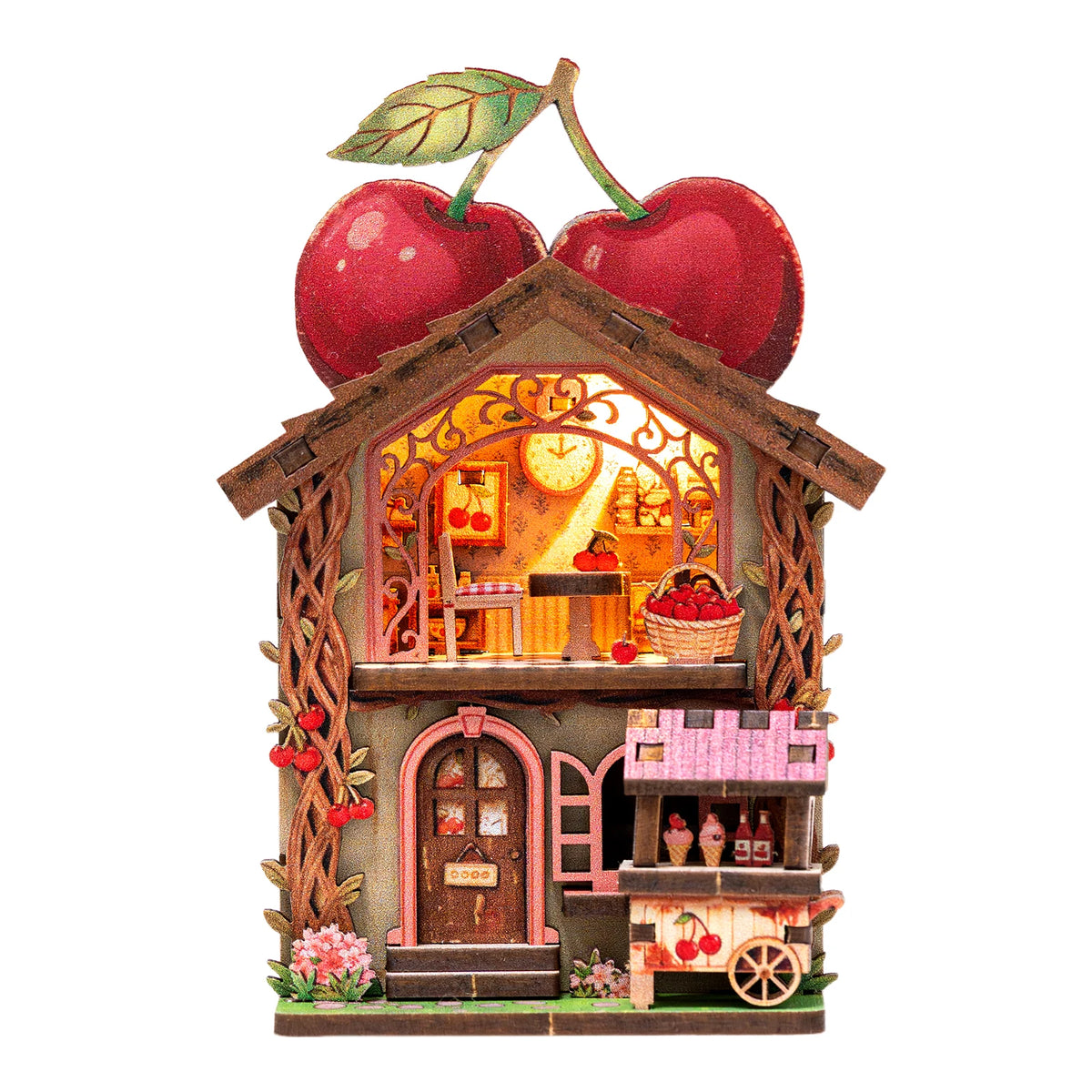 A miniature wooden book nook display featuring a fruit-themed scene with LED lighting and a large apple on top.