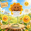 Handmade crochet sunflower plush doll with a wooden sign and yellow flowers