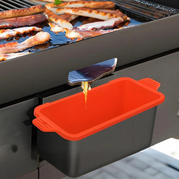 Reusable silicone grease cup liners dripping oil onto food being grilled on a barbecue grill.