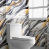 A modern white toilet in a bathroom with a marble effect wall covering featuring gray, white, and gold veining.
