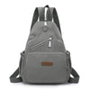 A gray waterproof nylon crossbody sling bag with adjustable straps and a zippered pocket.