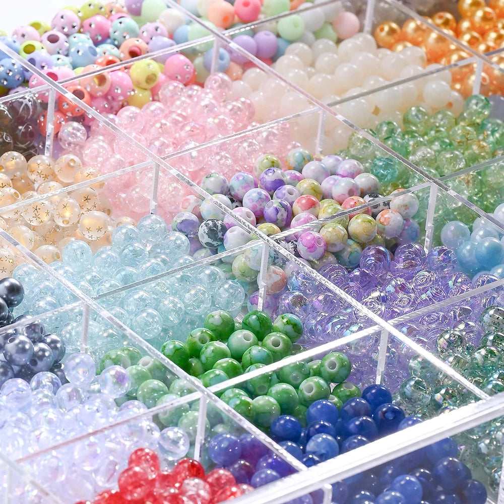 A clear box filled with various mixed colored acrylic beads for jewelry making