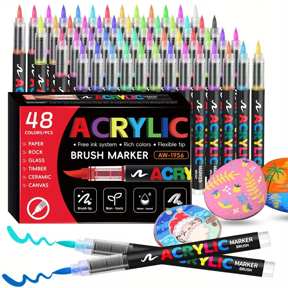 Una colección de marcadores de pintura acrílica en varios colores y puntas, mostrados en una caja y sueltos.